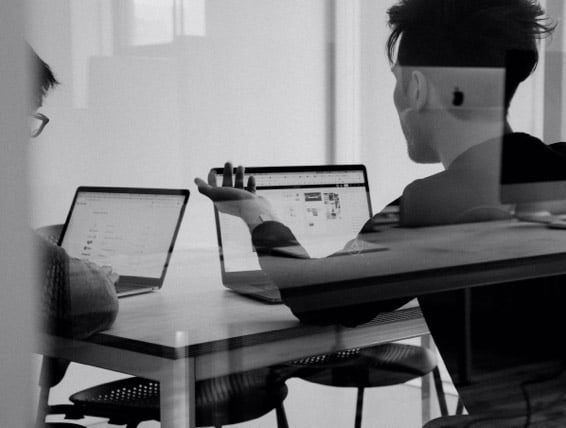 Two friends looking at computers in the early days